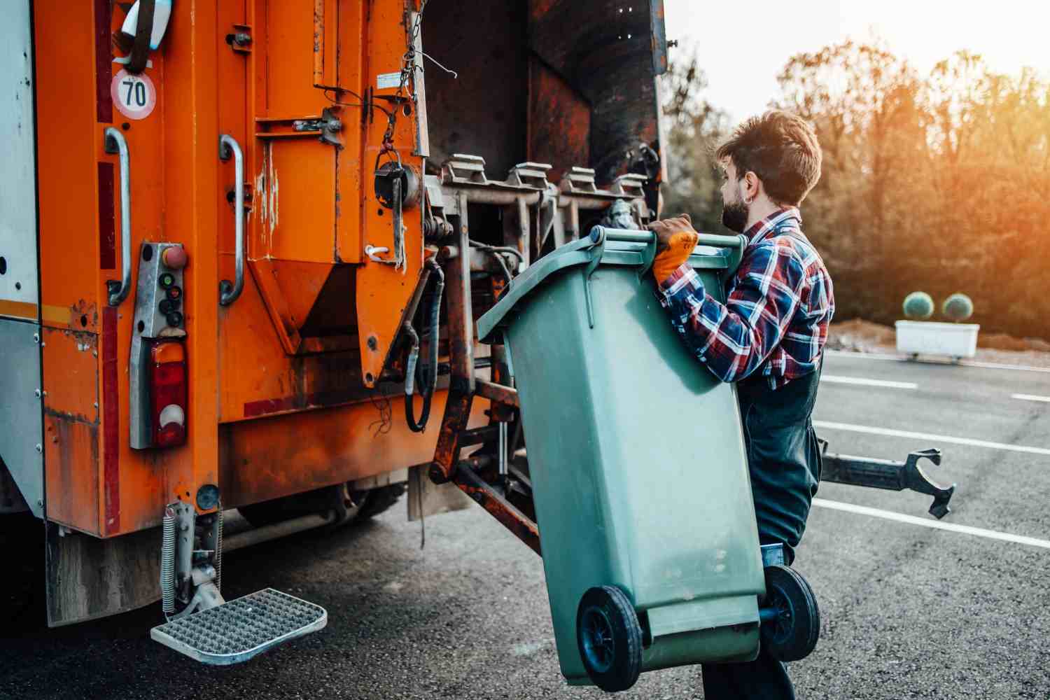 Commercial waste truck emptying a rolling trash bin for a business in Dallas, GA