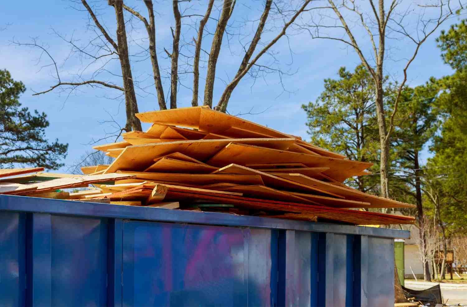 Construction debris stacked in a dumpster at an active job site in Acworth, GA