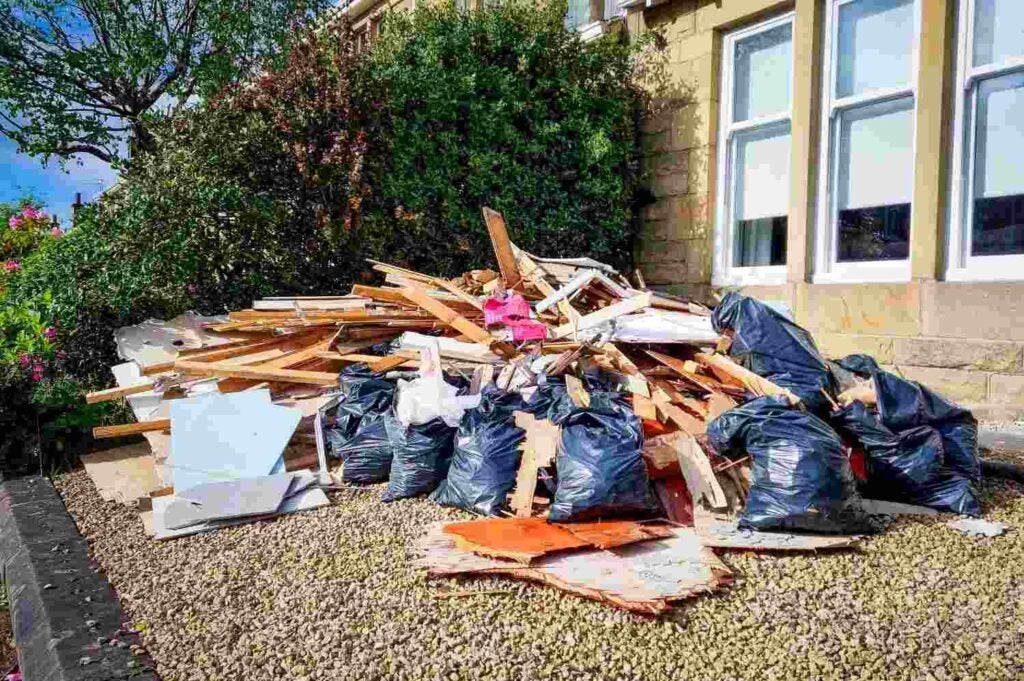 Pile of home renovation debris and trash bags awaiting dumpster rental in Acworth, GA