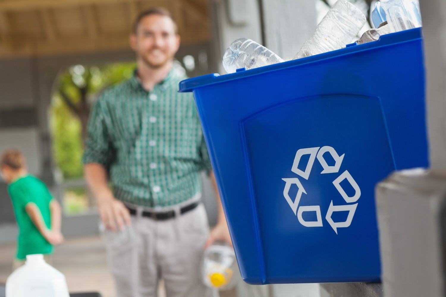 Blue residential recycling bin being used outside a home in Acworth, GA
